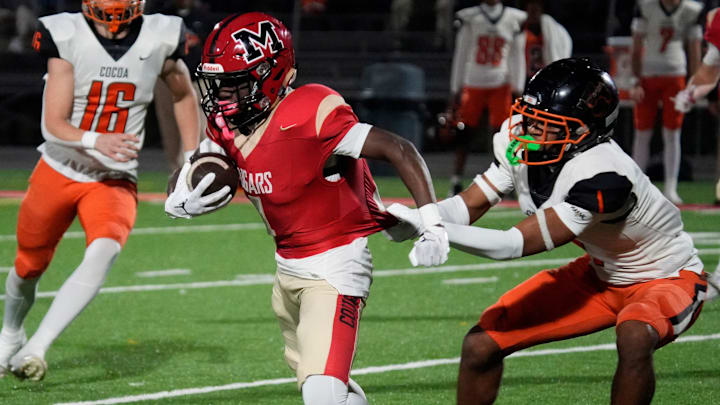 Cardinal Mooney ball carrier Marcus Galloway (#4) is stopped when Cocoa High defensive back CJ Hester (#1) grabs his jersey. Cocoa High School defeated Cardinal Mooney Catholic High School 31-21 to win the Class 2A semi-final game Friday night in Sarasota. Cardinal Mooney ball carrier Marcus Galloway (#4) is stopped when Cocoa High defensive back CJ Hester (#1) grabs his jersey. Cocoa High School defeated Cardinal Mooney Catholic High School 31-21 to win the Class 2A semi-final game Friday night in Sarasota.