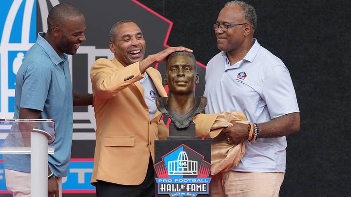 Aug 8, 2026; Canton, OH, USA; Pro Football Hall of Fame enshrinee Roger Craig presented by former teammate Jamie Williams and son Roderick Craig during the Class of 2026 enshrinement ceremony at Tom Benson Hall of Fame Stadium. Mandatory Credit: Kirby Lee-Imagn Images Aug 8, 2026; Canton, OH, USA; Pro Football Hall of Fame enshrinee Roger Craig presented by former teammate Jamie Williams and son Roderick Craig during the Class of 2026 enshrinement ceremony at Tom Benson Hall of Fame Stadium. Mandatory Credit: Kirby Lee-Imagn Images