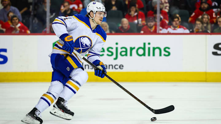 Jan 23, 2025; Calgary, Alberta, CAN; Buffalo Sabres defenseman Bowen Byram (4) skates with the puck against the Calgary Flames during the second period at Scotiabank Saddledome. Mandatory Credit: Sergei Belski-Imagn Images