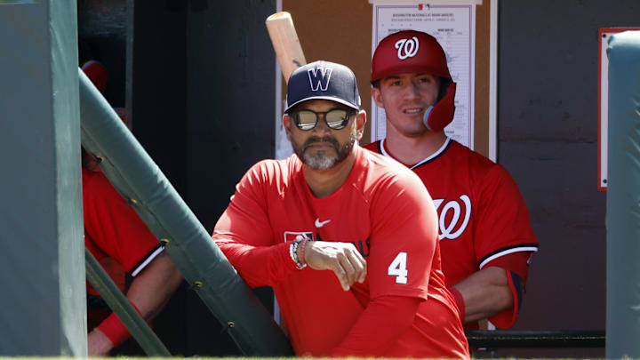 Feb 25, 2025; Jupiter, Florida, USA;  Washington Nationals manager Dave Martinez (4) watches a game from the dugout against the Miami Marlins during the first inning at Roger Dean Chevrolet Stadium.