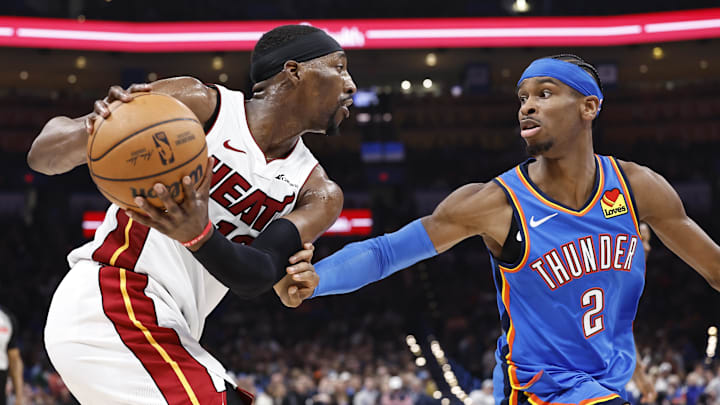 Mar 8, 2024; Oklahoma City, Oklahoma, USA; Miami Heat center Bam Adebayo (13) is defended by Oklahoma City Thunder guard Shai Gilgeous-Alexander (2) on a play during the second quarter at Paycom Center. Mandatory Credit: Alonzo Adams-Imagn Images