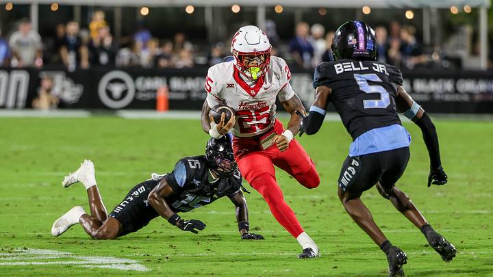 Nov 7, 2025; Orlando, Florida, USA; Houston Cougars running back DJ Butler (25) avoids a tackle during the first quarter against the UCF Knights at Acrisure Bounce House. Mandatory Credit: Mike Watters-Imagn Images