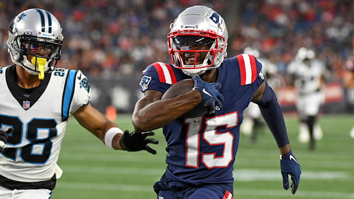 Aug 19, 2022; Foxborough, Massachusetts, USA; New England Patriots wide receiver Nelson Agholor (15) runs after making a catch with Carolina Panthers cornerback Keith Taylor Jr. (28) in pursuit during the first half of a preseason game at Gillette Stadium. Mandatory Credit: Eric Canha-Imagn Images