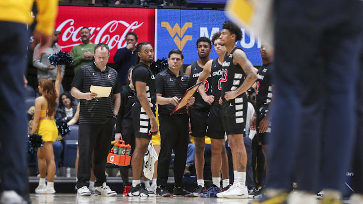 Feb 19, 2025; Morgantown, West Virginia, USA; Cincinnati Bearcats players pause during a timeout during the second half against the West Virginia Mountaineers at WVU Coliseum. Mandatory Credit: Ben Queen-Imagn Images
