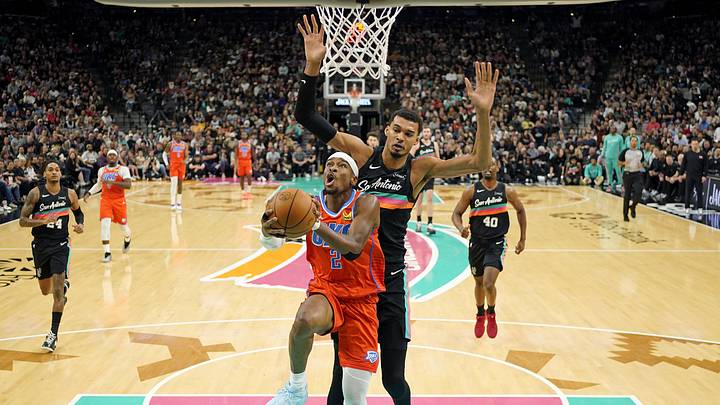 Dec 23, 2025; San Antonio, Texas, USA; Oklahoma City Thunder guard Shai Gilgeous-Alexander (2) drives to the basket past San Antonio Spurs forward Victor Wembanyama (1) during the first half at Frost Bank Center. Mandatory Credit: Scott Wachter-Imagn Images Dec 23, 2025; San Antonio, Texas, USA; Oklahoma City Thunder guard Shai Gilgeous-Alexander (2) drives to the basket past San Antonio Spurs forward Victor Wembanyama (1) during the first half at Frost Bank Center. Mandatory Credit: Scott Wachter-Imagn Images