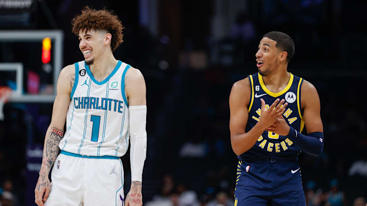 Oct 5, 2022; Charlotte, North Carolina, USA; Charlotte Hornets guard LaMelo Ball (1) and Indiana Pacers guard Tyrese Haliburton (0)