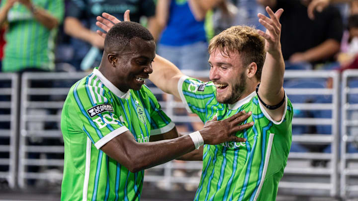 Seattle Sounders forward Pedro de la Vega (10), right, celebrates with defender Nouhou Tolo (5)