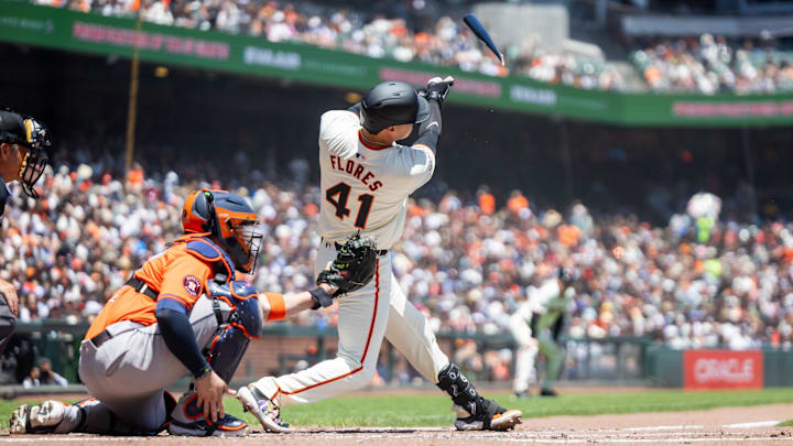 Jun 12, 2024; San Francisco, California, USA;  San Francisco Giants first base Wilmer Flores (41) drives in a run with a broken bat single during the third inning against the Houston Astros at Oracle Park.