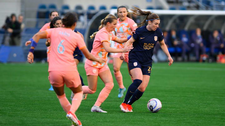 Seattle Reign FC forward Veronica Latsko (24) plays the ball while defended by Orlando Pride midfielder Coriana Dyke (31) at Lumen Field 