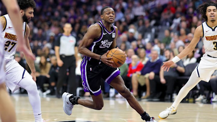 Dec 16, 2024; Sacramento, California, USA; Sacramento Kings guard De'Aaron Fox (5) drives to the basket against Denver Nuggets guard Jamal Murray (27) during the fourth quarter at Golden 1 Center. Mandatory Credit: Sergio Estrada-Imagn Images