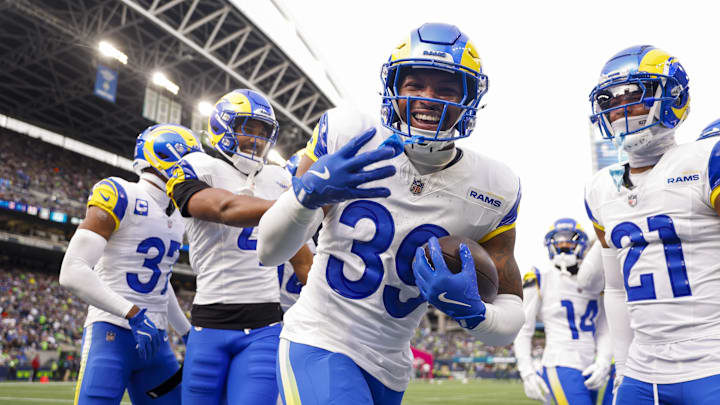 Nov 3, 2024; Seattle, Washington, USA; Los Angeles Rams safety Jaylen McCollough (39) celebrates with teammates, including cornerback Ahkello Witherspoon (4) and cornerback Charles Woods (21) following a first quarter interception against the Seattle Seahawks at Lumen Field. Mandatory Credit: Joe Nicholson-Imagn Images