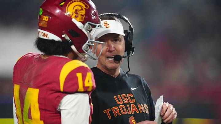 Nov 29, 2025; Los Angeles, California, USA; Southern California Trojans head coach Lincoln Riley (right) talks with quarterback Jayden Maiava (14) in the second half against the UCLA Bruins at United Airlines Field at Los Angeles Memorial Coliseum. Mandatory Credit: Kirby Lee-Imagn Images Nov 29, 2025; Los Angeles, California, USA; Southern California Trojans head coach Lincoln Riley (right) talks with quarterback Jayden Maiava (14) in the second half against the UCLA Bruins at United Airlines Field at Los Angeles Memorial Coliseum. Mandatory Credit: Kirby Lee-Imagn Images