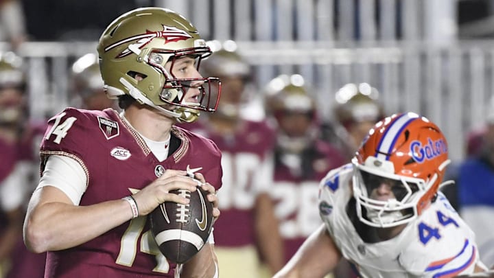 Nov 30, 2024; Tallahassee, Florida, USA; Florida State Seminoles quarterback Luke Kromenhoek (14) looks to pass during the first half against the Florida Gators at Doak S. Campbell Stadium. Mandatory Credit: Melina Myers-Imagn Images