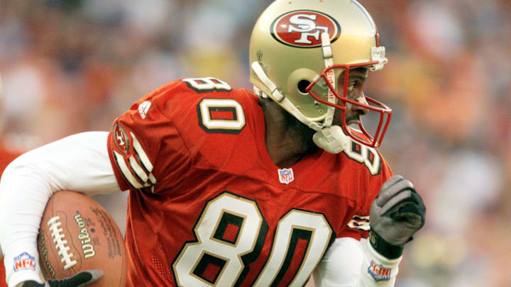 San Francisco receiver Jerry Rice heads up field with a pass during the 4th quarter of the 49ers' loss to the Rams at 3Com Park on Nov. 21,1999.