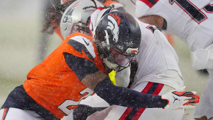 Jan 25, 2026; Denver, CO, USA; Denver Broncos cornerback Pat Surtain II (2) makes a tackle on New England Patriots running back Rhamondre Stevenson (38) during the second half in the 2026 AFC Championship Game at Empower Field at Mile High.