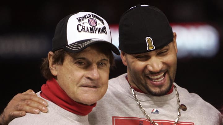 Oct 28, 2011; St. Louis, MO, USA; St. Louis Cardinals manager Tony La Russa (left) and first baseman Albert Pujols are interviewed on television after defeating the Texas Rangers 6-2 in game seven of the 2011 World Series at Busch Stadium.  The Cardinals won the series four games to three. Mandatory Credit: Jerry Lai-Imagn Images