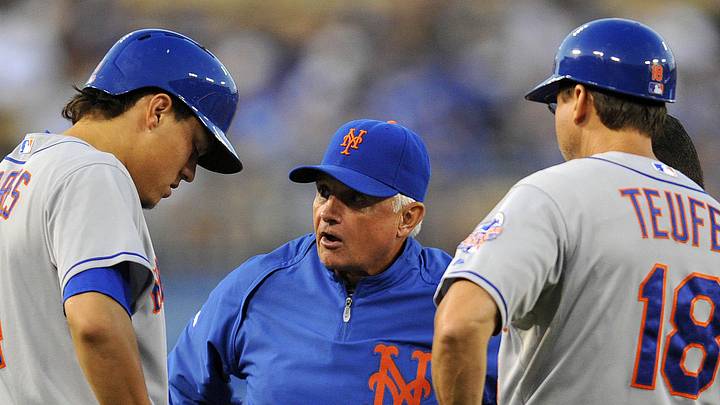 August 12, 2013; Los Angeles, CA, USA; New York Mets manager Terry Collins (10) meets with third baseman Wilmer Flores (4) at third base during the second inning at Dodger Stadium. Mandatory Credit: Gary A. Vasquez-Imagn Images
