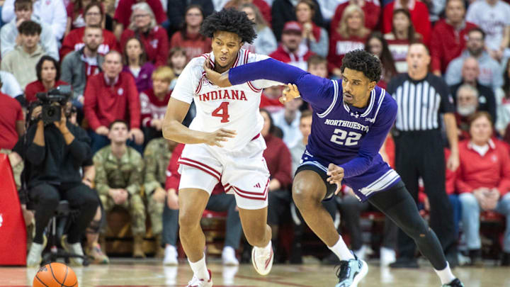 Indiana's Sam Alexis and Northwestern's Arrinten Page (22) head for a loose ball during the Indiana versus Northwestern men's basketball game at Simon Skjodt Assembly Hall on Tuesday, Feb. 24, 2026.