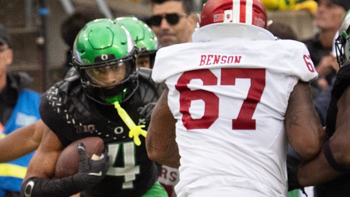 Oregon’s Brandon Finney Jr., left, runs into the end zone for a pick-six against Indiana in the fourth quarter at
Autzen Stadium October 11, 2025.