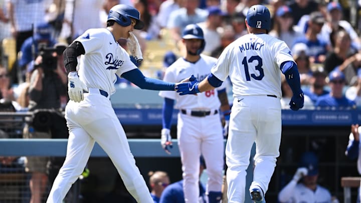 Apr 20, 2024; Los Angeles, California, USA; Los Angeles Dodgers designated hitter Shohei Ohtani (17) fives third baseman Max Muncy (13) after scoring against the New York Mets during the fifth inning at Dodger Stadium. Mandatory Credit: Jonathan Hui-Imagn Images