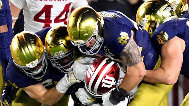 Notre Dame Fighting Irish defensive lineman Joshua Burnham (40) and teammates tackle Indiana Hoosiers wide receiver Myles Price (4) during the third quarter at Notre Dame Stadium.