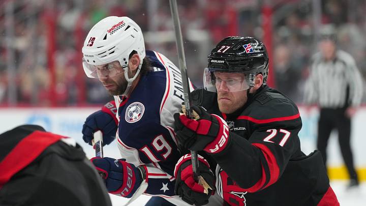 Apr 2, 2026; Raleigh, North Carolina, USA; Columbus Blue Jackets center Adam Fantilli (19) and Carolina Hurricanes left wing Nikolaj Ehlers (27) battle for position during the second period at Lenovo Center. Mandatory Credit: James Guillory-Imagn Images