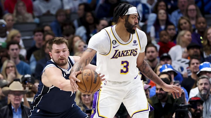 Feb 26, 2023; Dallas, Texas, USA: Dallas Mavericks guard Luka Doncic (77) tries to knock the ball away from Los Angeles Lakers forward Anthony Davis (3) during the first quarter at American Airlines Center. Mandatory Credit: Kevin Jairaj-Imagn Images