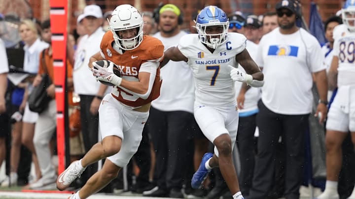 Sep 6, 2025; Austin, Texas, USA; Texas Longhorns wide receiver Parker Livingstone (13) runs for yards while defended by San Jose State Spartans defensive back Jalen Apalit-Williams (7) during the first half at Darrell K Royal-Texas Memorial Stadium. Mandatory Credit: Scott Wachter-Imagn Images