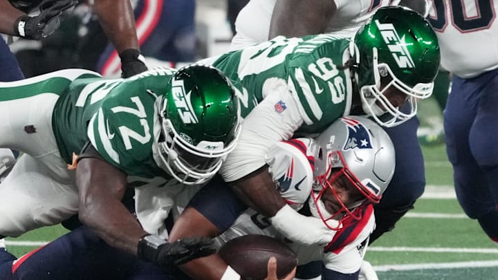 Sep 19, 2024; East Rutherford, New Jersey, USA; New England Patriots quarterback Jacoby Brissett (7) sacked by New York Jets defensive end Micheal Clemons (72) and defensive end Will McDonald IV (99) in the 1st half at MetLife Stadium. Sep 19, 2024; East Rutherford, New Jersey, USA; New England Patriots quarterback Jacoby Brissett (7) sacked by New York Jets defensive end Micheal Clemons (72) and defensive end Will McDonald IV (99) in the 1st half at MetLife Stadium.