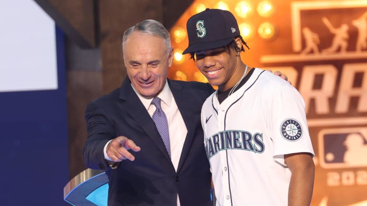 MLB Commissioner Rob Manfred (left) takes a photo with Jurrangelo Cijntje after being drafted by the Seattle Mariners with the 15th pick during the first round of the MLB Draft on Sunday at Cowtown Coliseum.