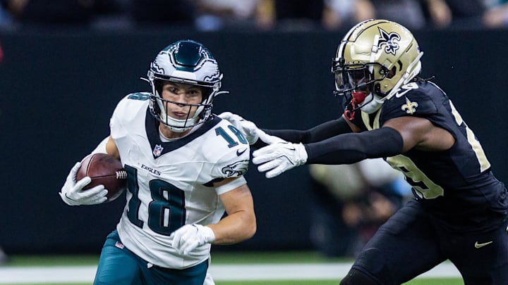 Sep 22, 2024; New Orleans, Louisiana, USA; Philadelphia Eagles wide receiver Britain Covey (18) runs a pass back against New Orleans Saints cornerback Paulson Adebo (29) during the first half at Caesars Superdome. Mandatory Credit: Stephen Lew-Imagn Images