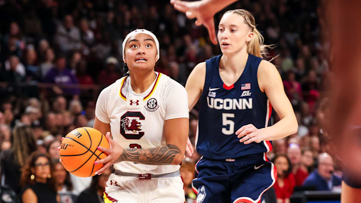 Feb 16, 2025; Columbia, South Carolina, USA; South Carolina Gamecocks guard Te-Hina Paopao (0) drives past UConn Huskies guard Paige Bueckers (5) in the first half at Colonial Life Arena. Mandatory Credit: Jeff Blake-Imagn Images