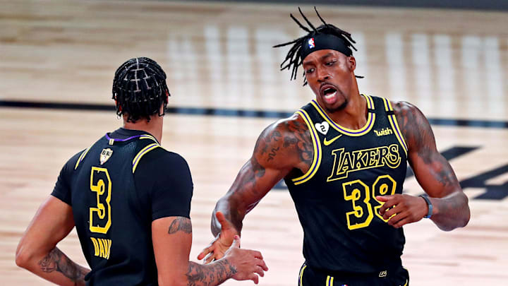 Oct 2, 2020; Orlando, Florida, USA;  Los Angeles Lakers center Dwight Howard (39) celebrates with forward Anthony Davis (3) after a play against the Miami Heat during the first quarter in game two of the 2020 NBA Finals at AdventHealth Arena. Mandatory Credit: Kim Klement-Imagn Images