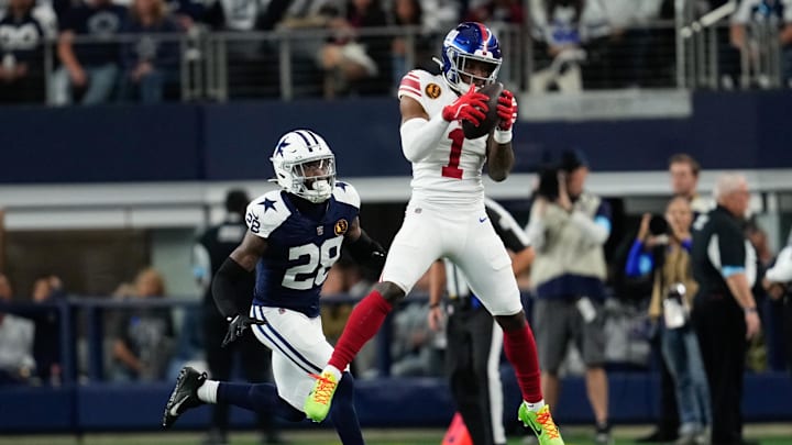 Nov 28, 2024; Arlington, Texas, USA;  New York Giants wide receiver Malik Nabers (1) catches a pass as Dallas Cowboys safety Malik Hooker (28) gives chase during the first half at AT&T Stadium. Mandatory Credit: Chris Jones-Imagn Images