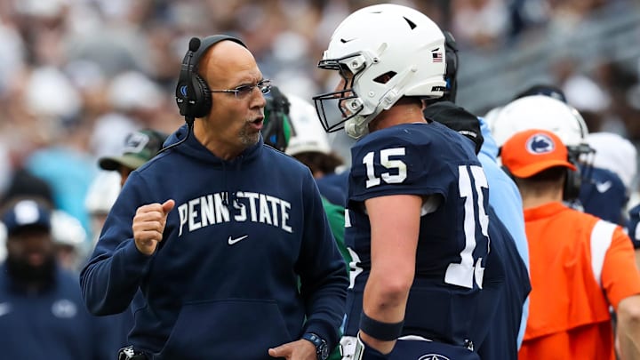 Penn State Nittany Lions head coach James Franklin talks with  quarterback Drew Allar (15) 