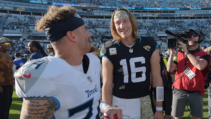 Jacksonville Jaguars quarterback Trevor Lawrence (16) talks with Tennessee Titans cornerback Elijah