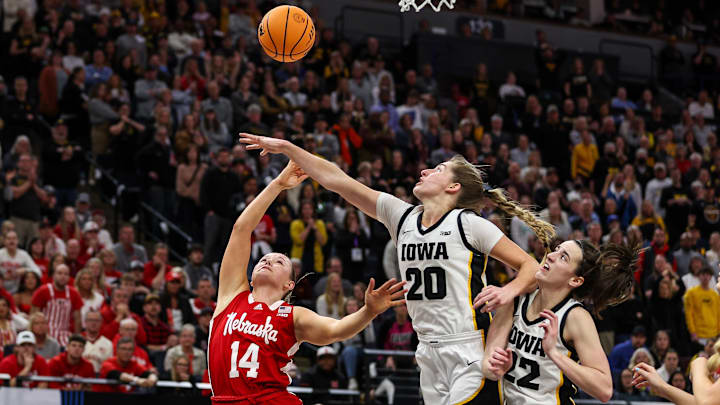 Nebraska guard Callin Hake (14) shoots as Iowa guard Kate Martin (20) defends in the 2025 Big Ten Tournament Championship.