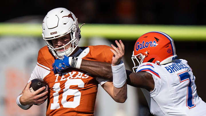 Texas Longhorns quarterback Arch Manning (16) shakes off a tackle attempt from Florida Gators defensive back Trikweze Bridges (7) in the fourth quarter of the Longhorns' game against the Florida Gators, Nov. 9, 2024 at Darrell K. Royal Texas Memorial Stadium in Austin.
