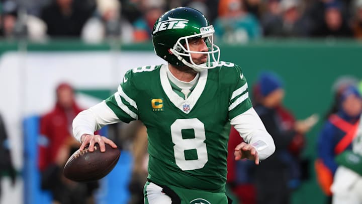 Jan 5, 2025; East Rutherford, New Jersey, USA; New York Jets quarterback Aaron Rodgers (8) throws a pass during the first quarter of their game against the Miami Dolphins at MetLife Stadium. Mandatory Credit: Ed Mulholland-Imagn Images