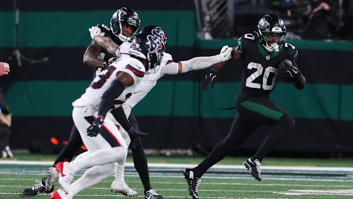 Oct 31, 2024; East Rutherford, New Jersey, USA; New York Jets running back Breece Hall (20) runs with the ball against the Houston Texans during the second half at MetLife Stadium. Mandatory Credit: Ed Mulholland-Imagn Images