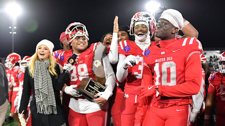 Mater Dei football players are all smiles with the 2024 CIF State Open Division trophy after beating De La Salle 37-15 at Saddleback College in Mission Viejo.