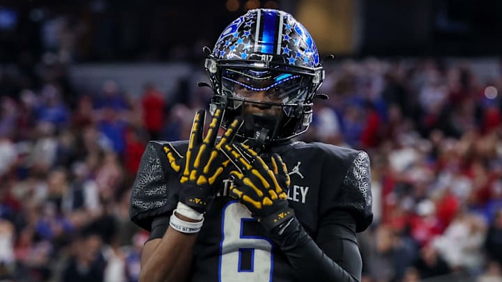 Receiver Quentin Gibson of North Crowley signals that he and his teammates will be receiving a championship ring after defeating Westlake in the Texas 6A Division 1 state title game at AT&T Stadium.