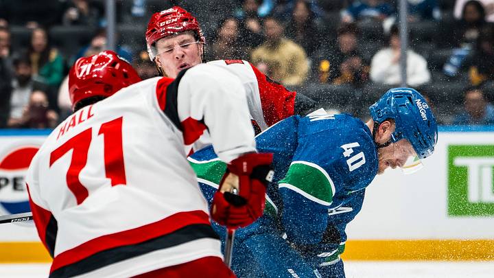 Mar 4, 2026; Vancouver, British Columbia, CAN; Carolina Hurricanes forward Jackson Blake (53) and forward Taylor Hall (71) checks Vancouver Canucks forward Elias Pettersson (40) in the second period at Rogers Arena. Mandatory Credit: Bob Frid-Imagn Images