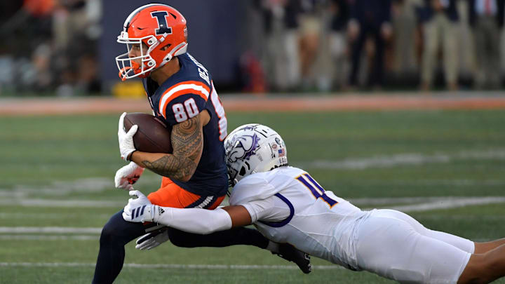 Aug 29, 2025; Champaign, Illinois, USA;  Illinois Fighting Illini wide receiver Hank Beatty (80) runs the ball after a pass reception as Western Illinois Leathernecks defensive back Buju Aumua-Tuisavura (14) tackles during the first half at Memorial Stadium. Mandatory Credit: Ron Johnson-Imagn Images