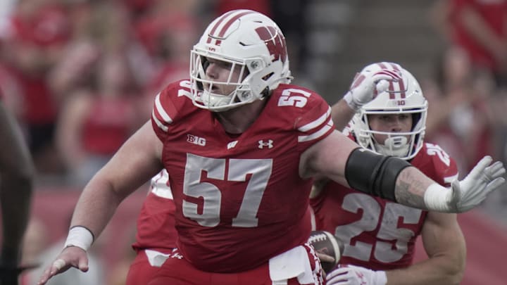 Oct 18, 2025; Madison, Wisconsin, USA;  Wisconsin offensive lineman Jake Renfro (57) provides pas protection during the fourth quarter of their game against Ohio State at Camp Randall Stadium.