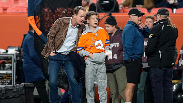 Dec 2, 2024; Denver, Colorado, USA; Former Denver Broncos player Peyton Manning with his son Marshall before the game against the Cleveland Browns at Empower Field at Mile High. Mandatory Credit: Isaiah J. Downing-Imagn Images