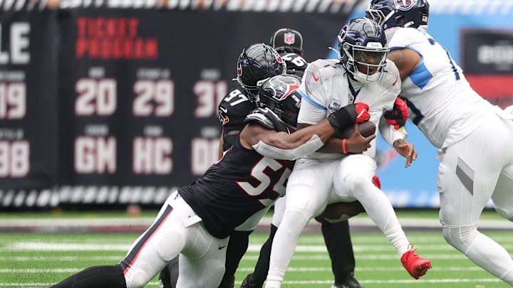 Sep 28, 2025; Houston, Texas, USA; Houston Texans defensive end Danielle Hunter (55) sacks Tennessee Titans quarterback Cam Ward (1) during the first half at NRG Stadium. Mandatory Credit: Troy Taormina-Imagn Images
