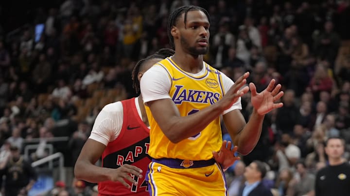 Nov 1, 2024; Toronto, Ontario, CAN; Los Angeles Lakers guard Bronny James (9) looks for a pass as Toronto Raptors guard Ja'Kobe Walter (14) defends during the second half at Scotiabank Arena. Mandatory Credit: John E. Sokolowski-Imagn Images