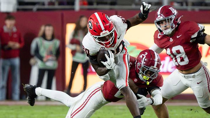 Georgia running back Dwight Phillips Jr. tries to avoid the tackle attempt of Alabama defensive back Zabien Brown (2) at Saban Field at Bryant-Denny Stadium.