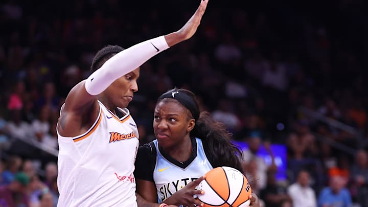 Aug 28, 2025; Phoenix, Arizona, USA; Chicago Sky forward Michaela Onyenwere (12) against Phoenix Mercury forward Natasha Mack (4) at Phx Arena. Mandatory Credit: Mark J. Rebilas-Imagn Images